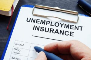 Close-up of identity thief filling out an unemployment insurance form.